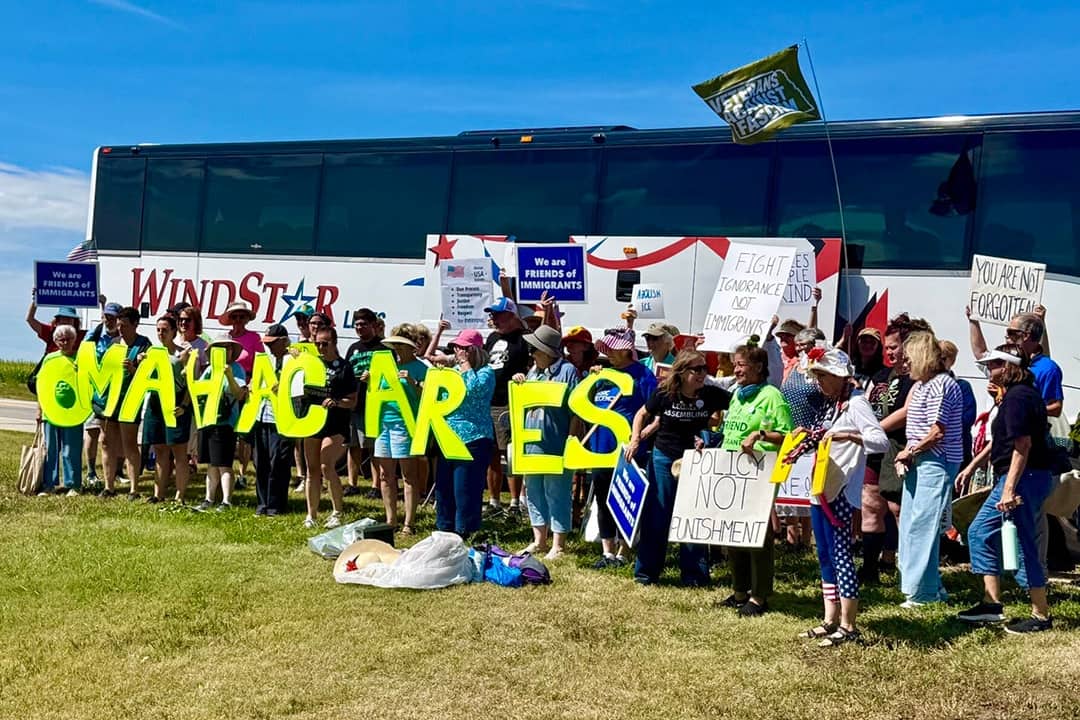 Protestors traveled 10 hours round trip on a bus road to attend an Aug. 15 rally within eyeshot of a McCook, Nebraska-based U.S. Immigration and Customs Enforcement detention center that started holding migrants last November. The rally marks a year since Gov. Jim Pillen’s administration announced a partnership with ICE to house immigrant detainees.